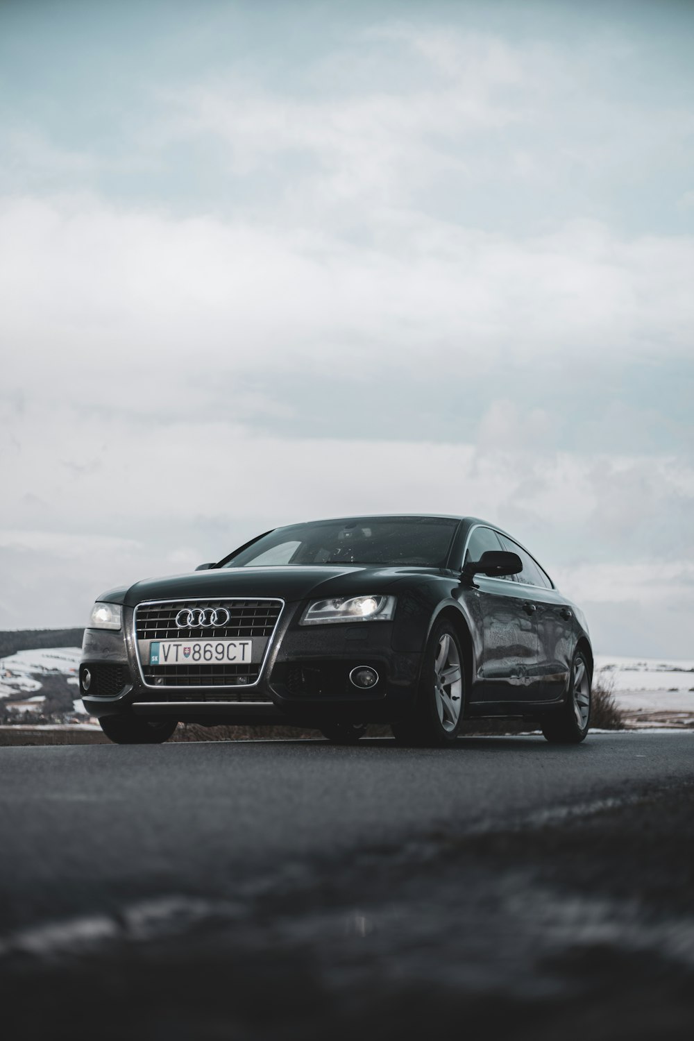 a black car parked on the side of the road