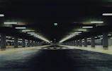 an empty parking garage with lights on the ceiling