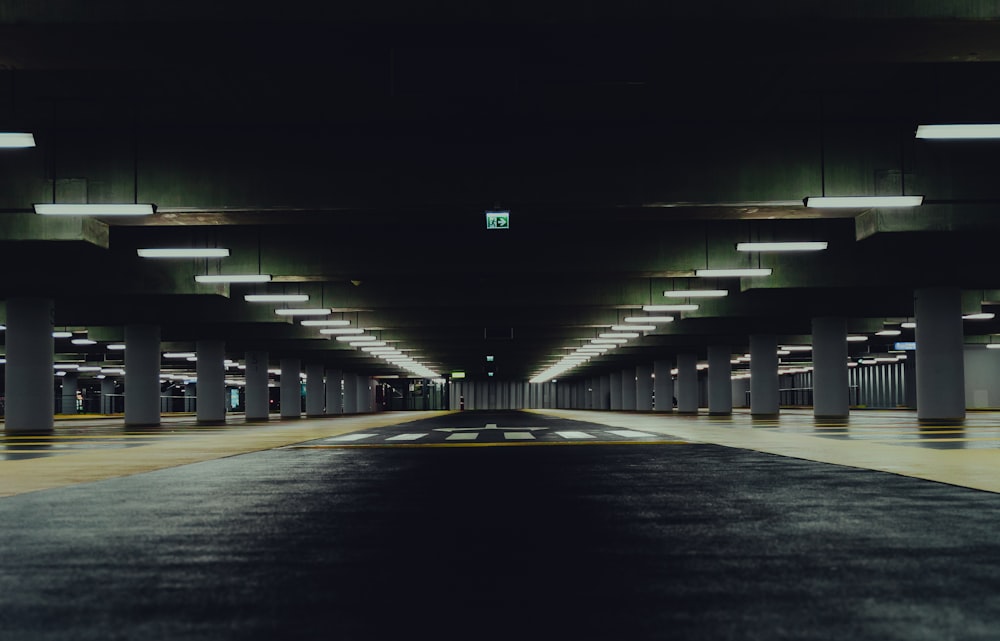 an empty parking garage with lights on the ceiling