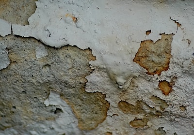 a close up of a wall with peeling paint