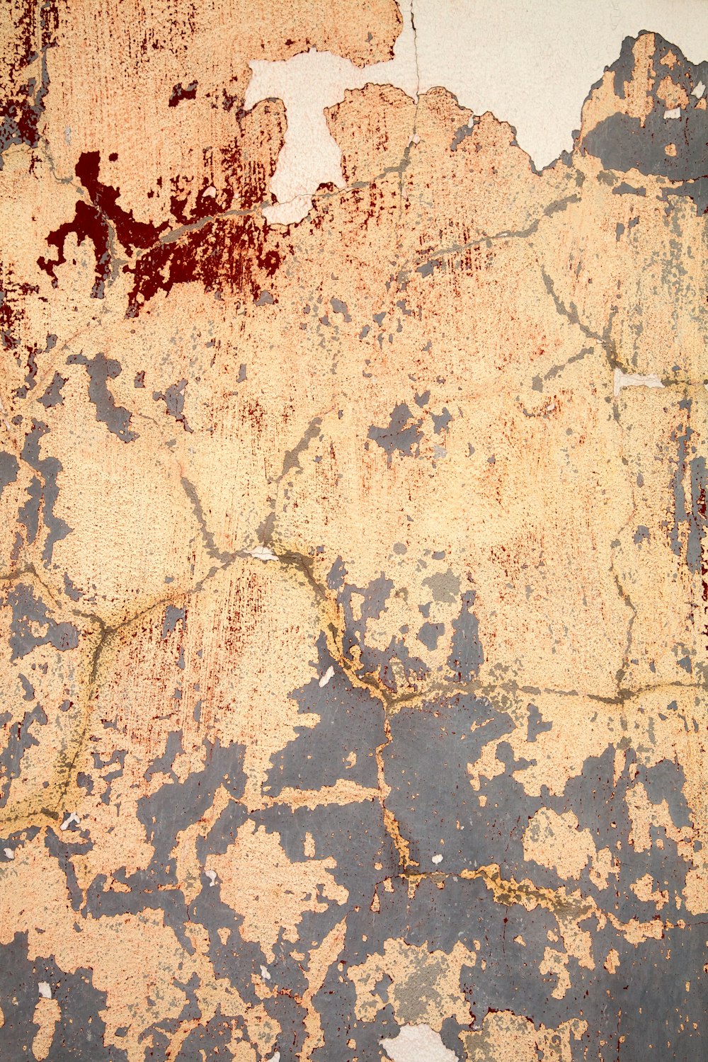 a close up of a wall with peeling paint