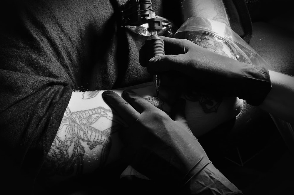 a man getting a tattoo on his arm