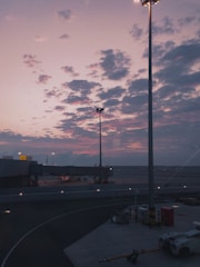 A serene view of airplanes taxiing and taking off at Munich Airport during golden hour.