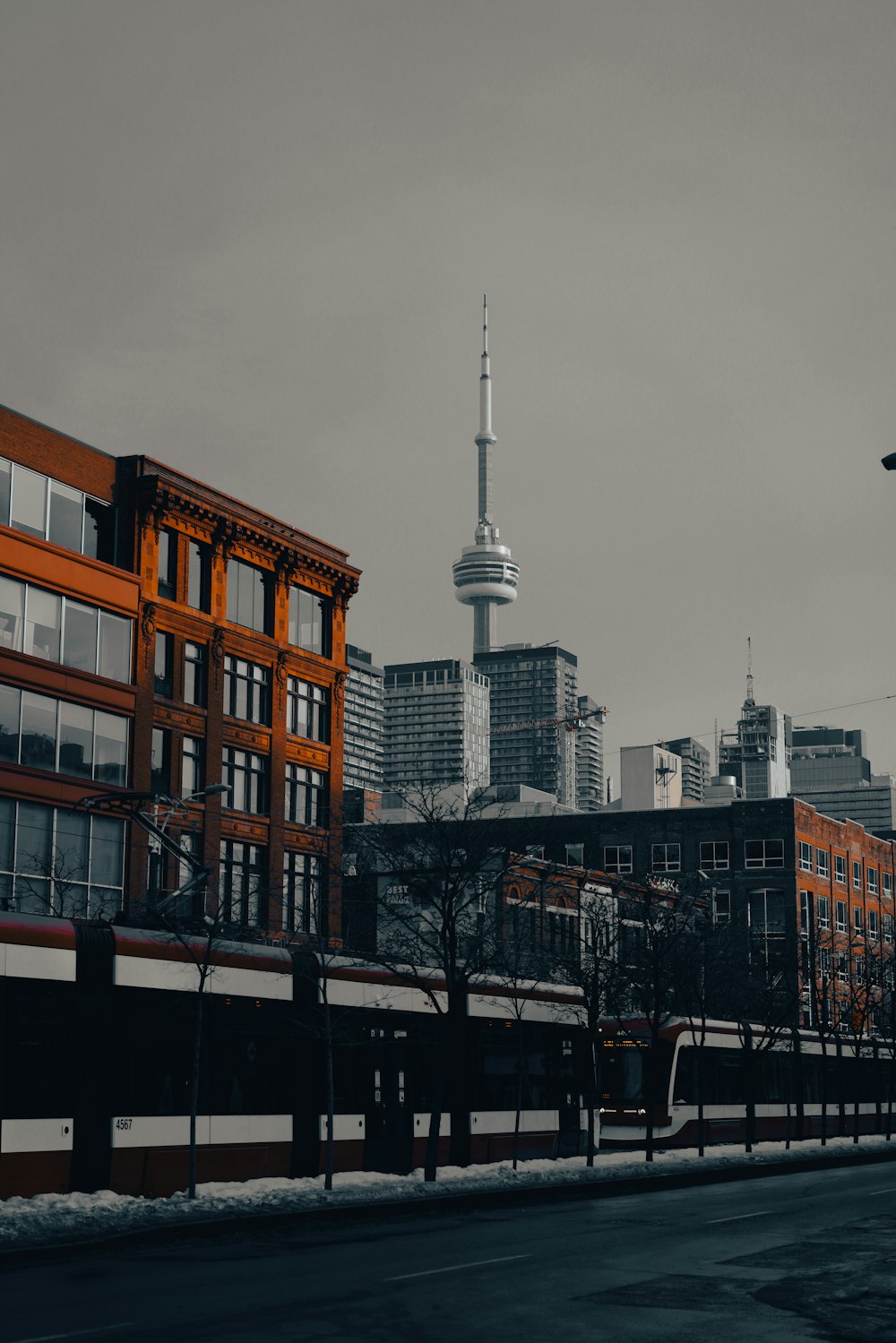 a train traveling past a tall building in a city