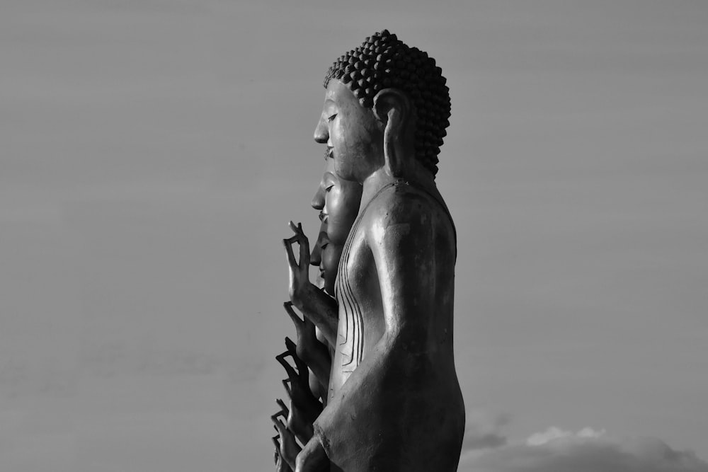 a black and white photo of a buddha statue