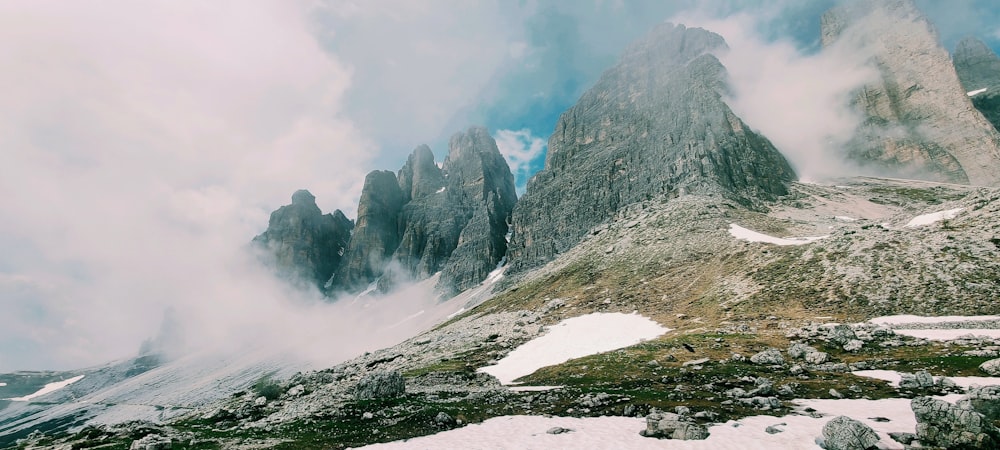 a group of mountains with snow on the ground