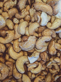 Close-up of crunchy roasted foxnuts sprinkled with Himalayan pink salt on a rustic wooden plate.