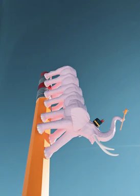 A whimsical sculpture of pink elephants stacked on top of a large pencil against a clear blue sky. The elephants wear hats and one is holding a staff.