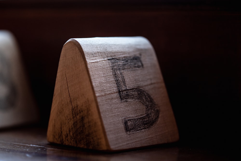 a close up of a wooden block on a table