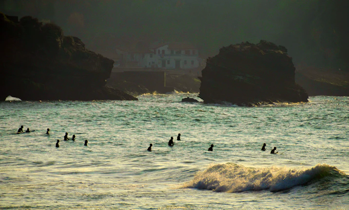 Swimmers powering through turquoise ocean waters near El Arco at sunrise