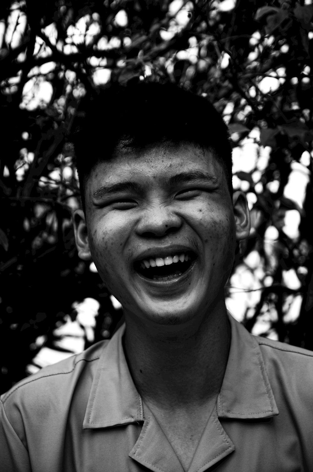 a black and white photo of a man laughing