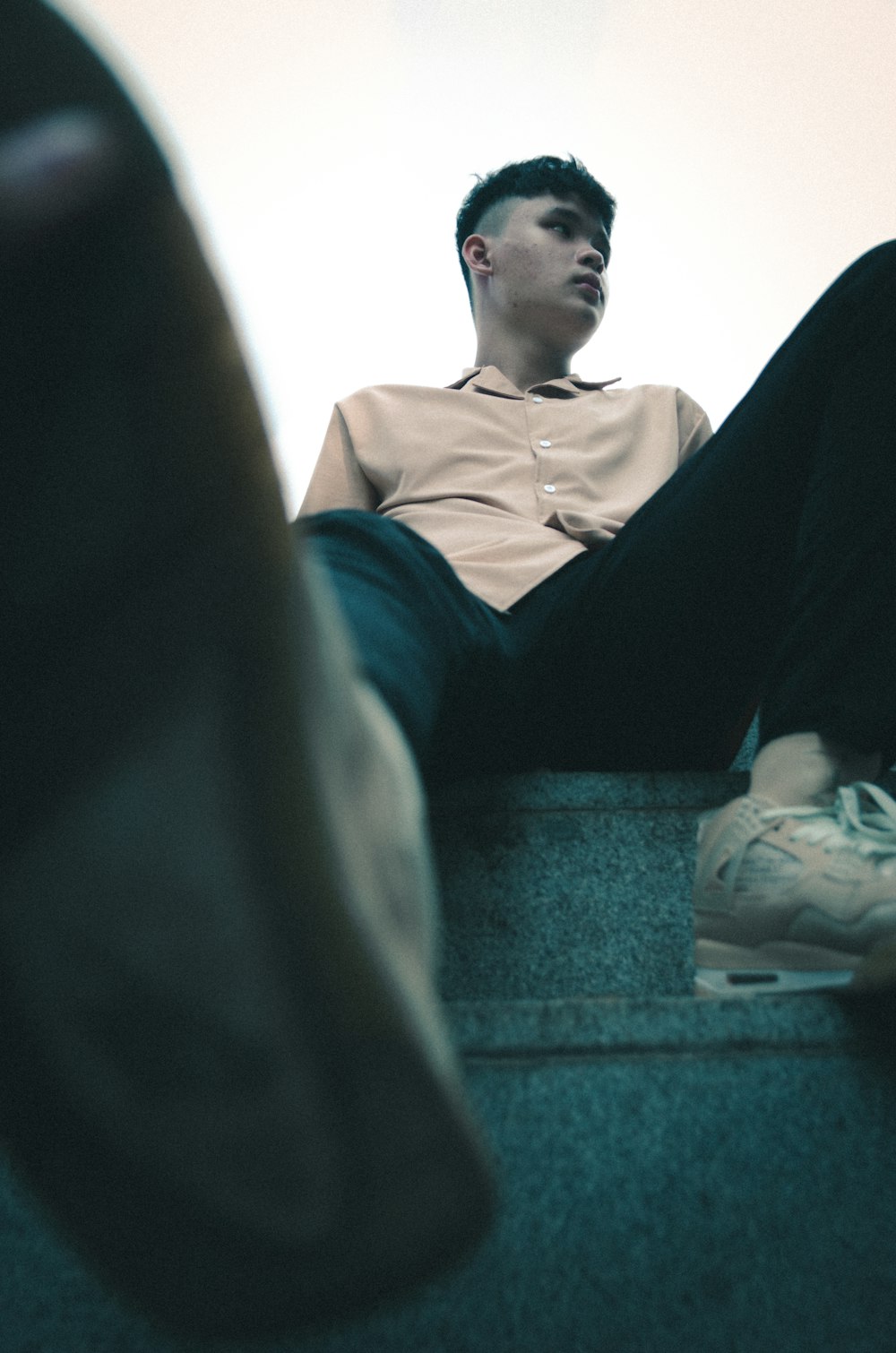 a man sitting on a ledge with his feet up