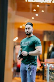 a man standing in front of a store window