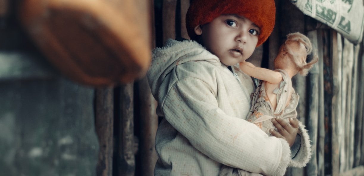 a little girl holding a stuffed animal in her arms