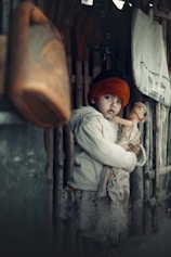 a little girl holding a stuffed animal in her arms