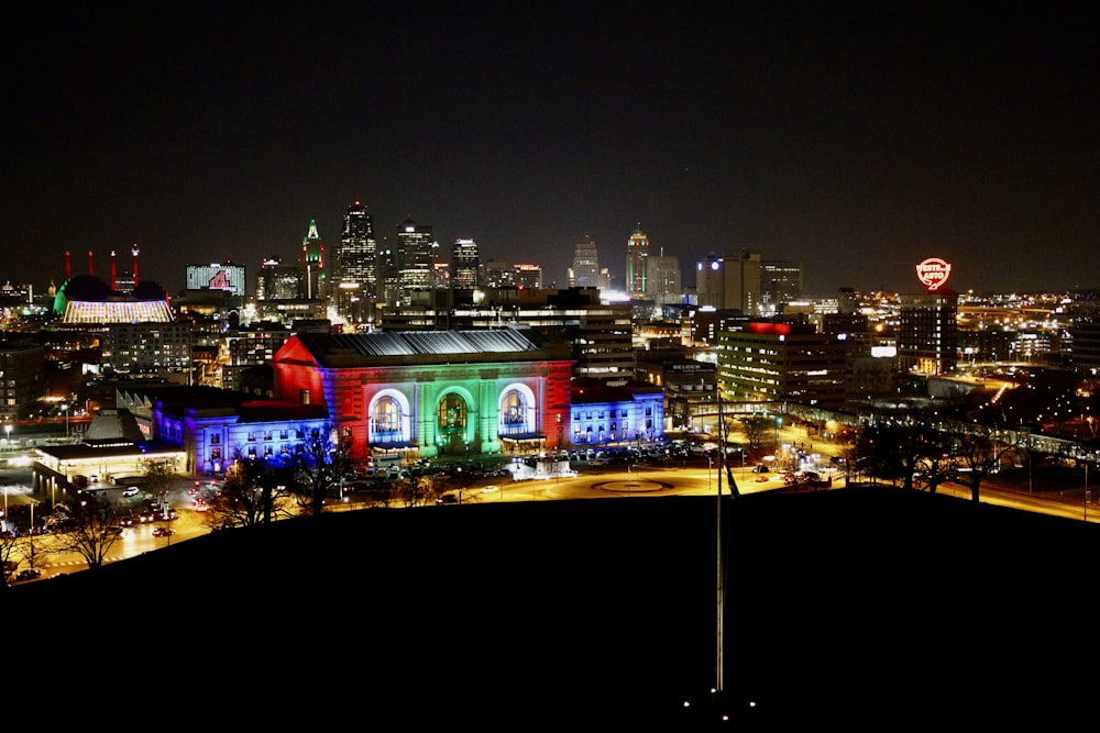 a view of a city at night from a hill