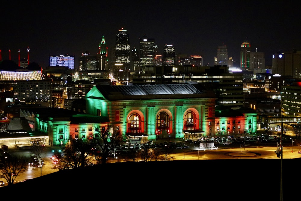 a large building lit up with green and red lights