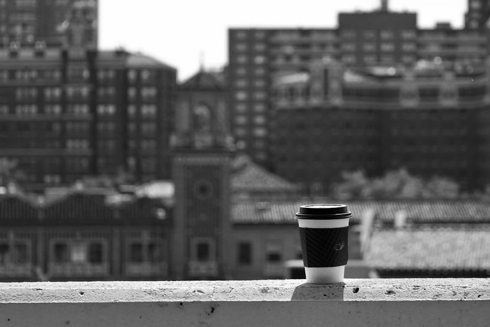 a cup of coffee sitting on top of a ledge