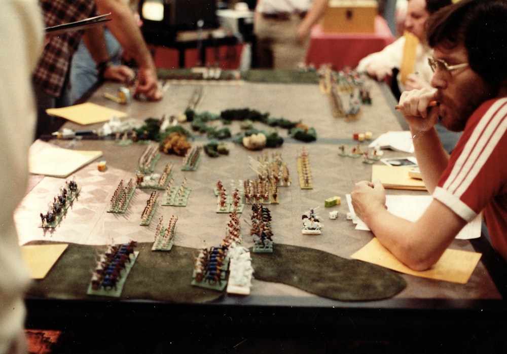 a group of people sitting around a table playing a game