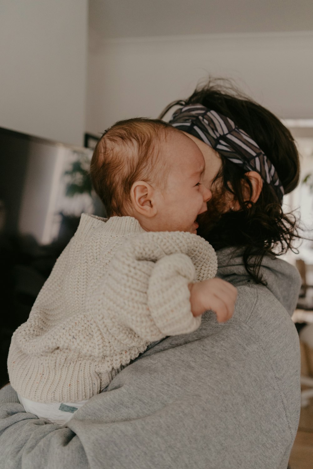 a woman holding a baby in her arms