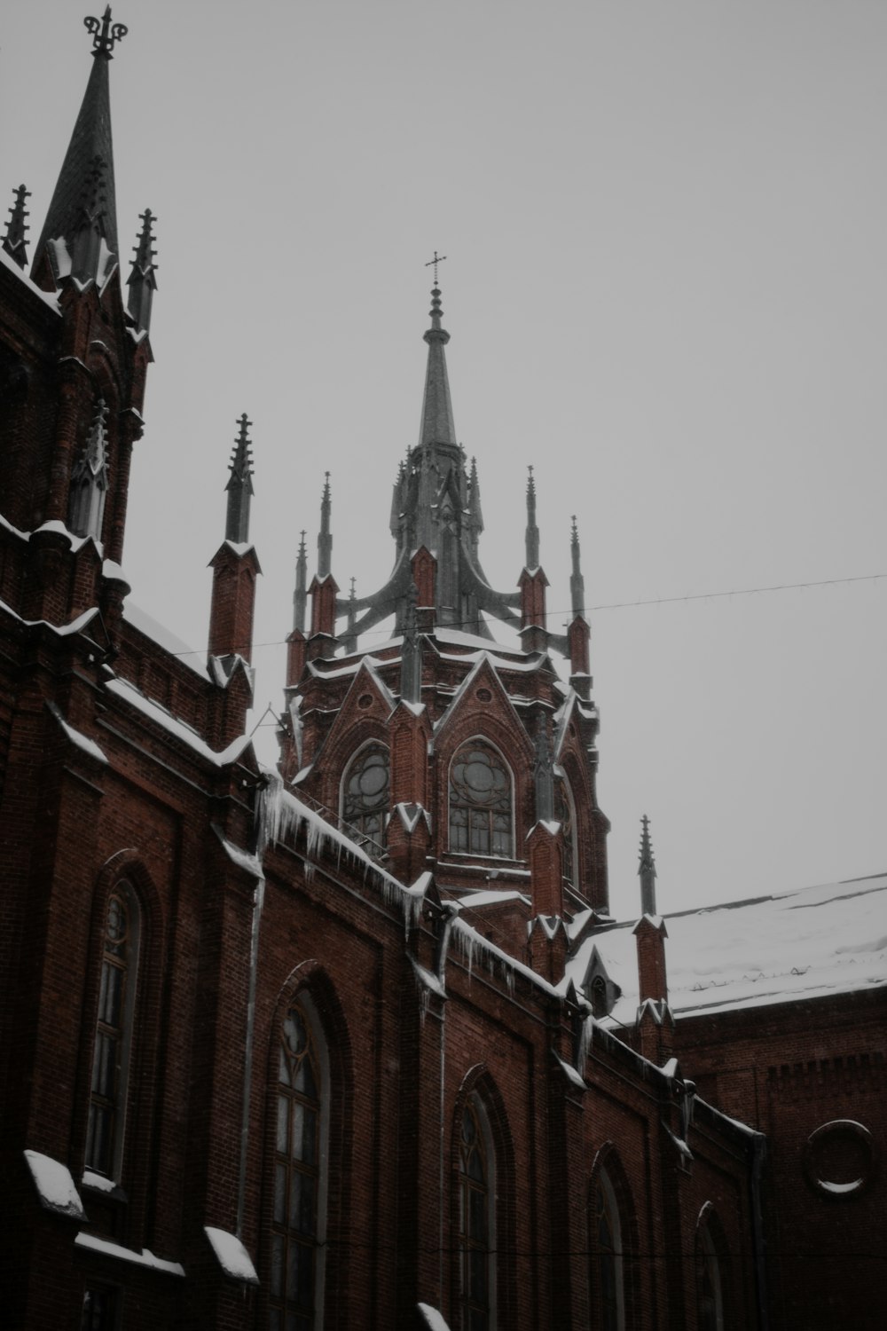 a church with a steeple covered in snow