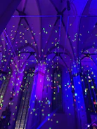 A church interior blending Gothic design with modern Afrofuturist lighting.