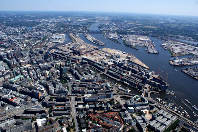 An aerial view of a city and its port on a winding river