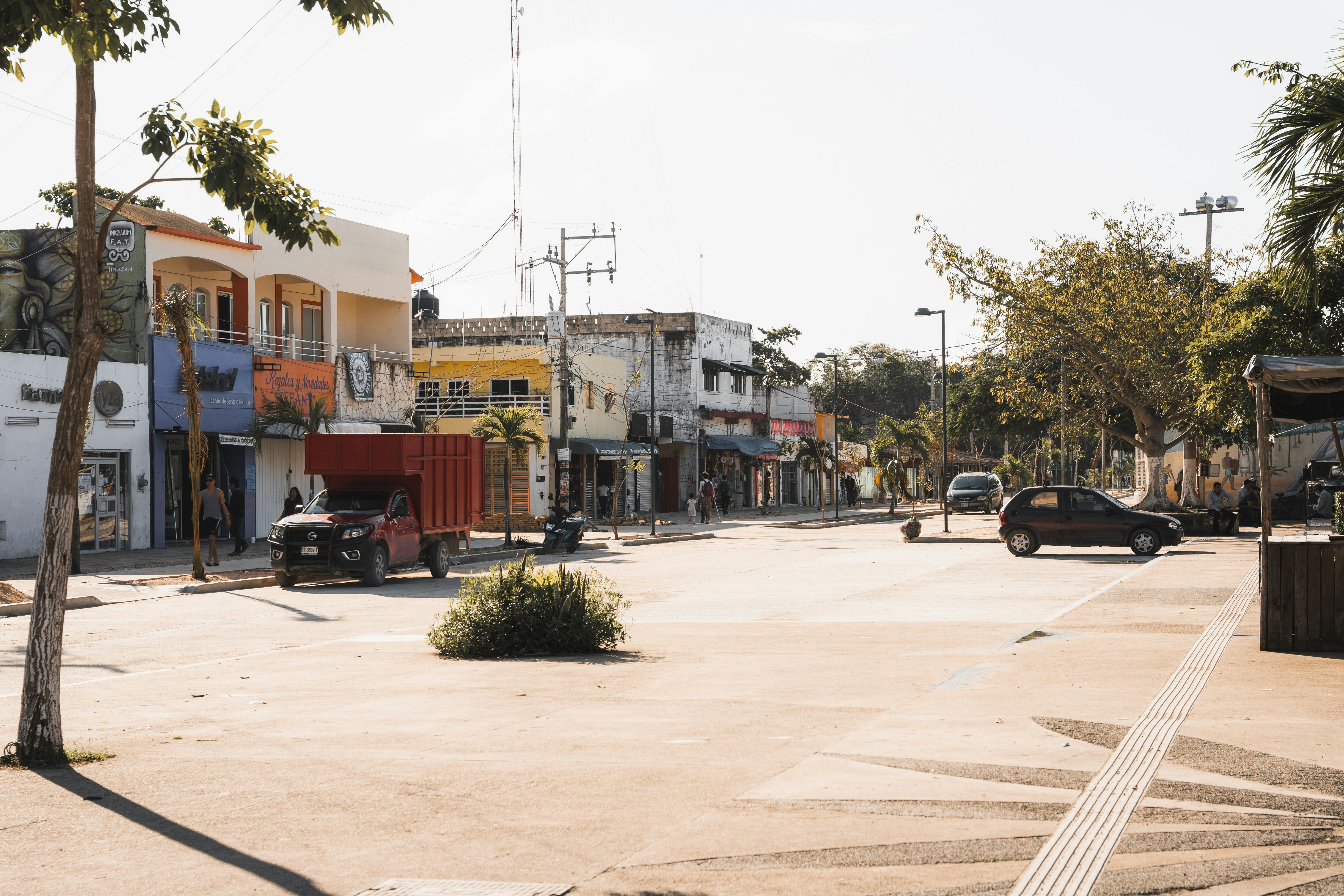 a street scene with a car parked on the side of the road