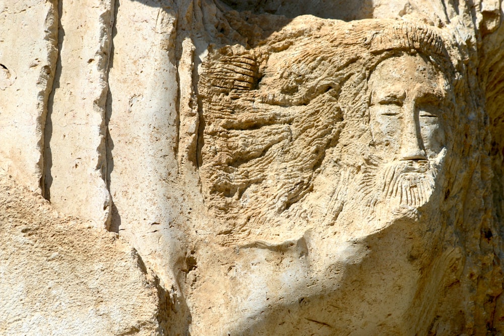 a close up of a face carved into a rock