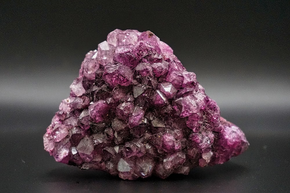 a cluster of purple crystals sitting on top of a table