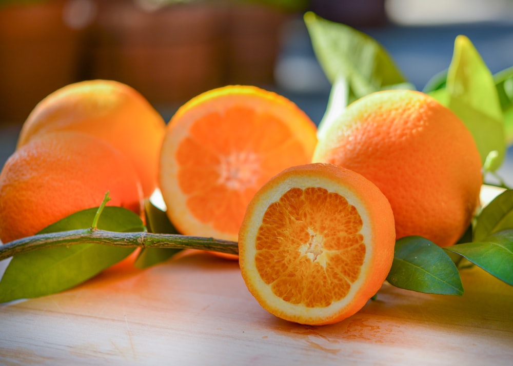 a group of oranges sitting on top of a wooden table