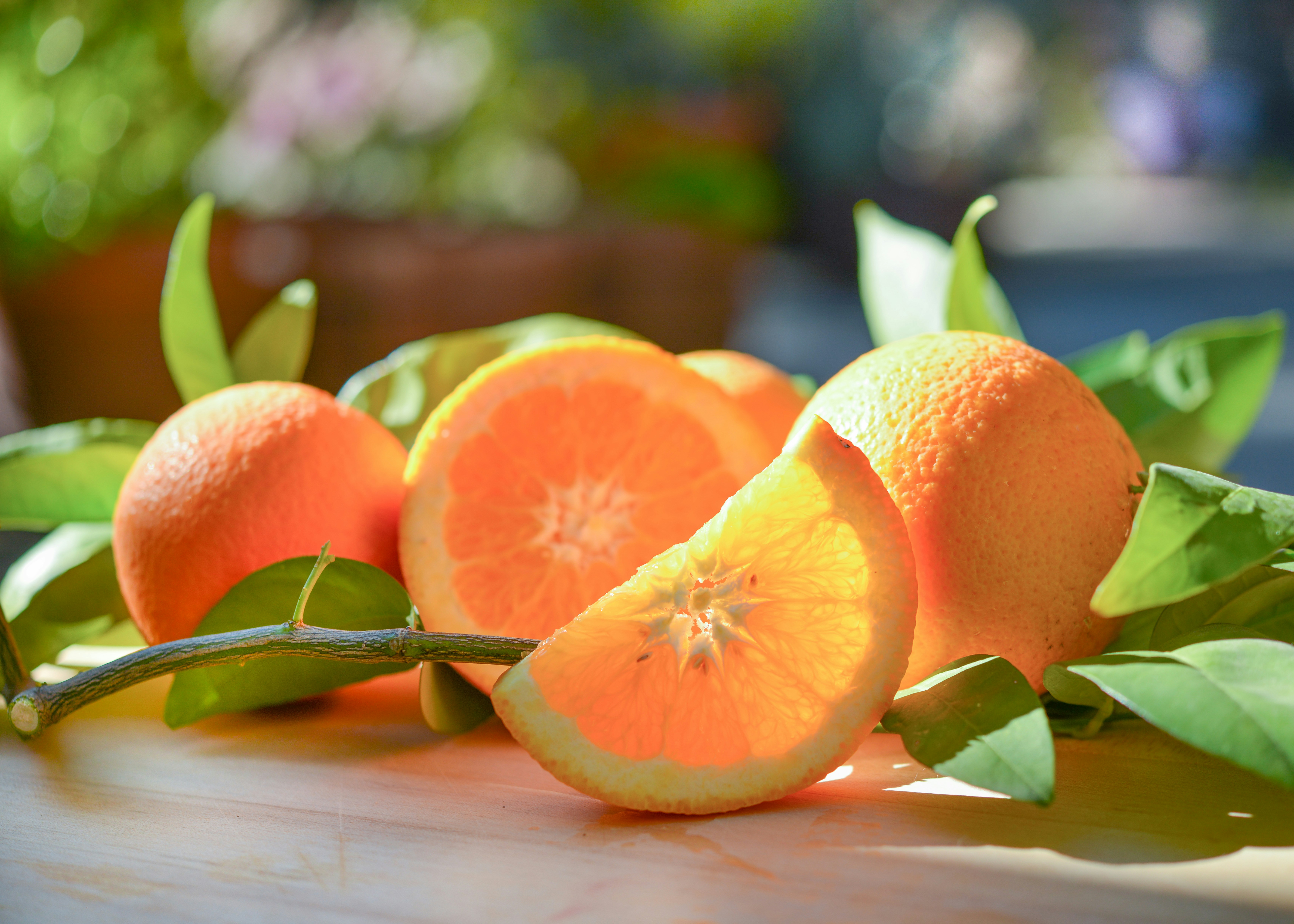 a group of oranges sitting on top of a wooden table