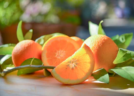 a group of oranges sitting on top of a wooden table