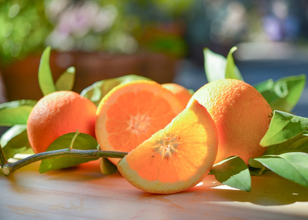 a group of oranges sitting on top of a wooden table