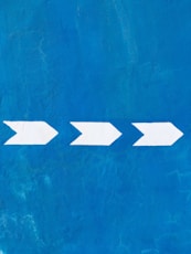 a blue wall with a white arrow painted on it