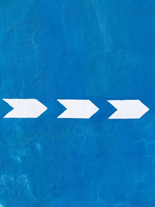 a blue wall with a white arrow painted on it