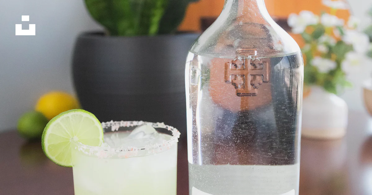 A close up of a bottle of alcohol on a table photo – Free Alcohol Image ...