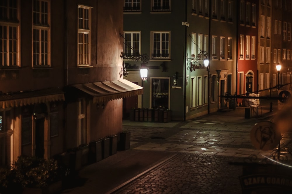 a city street at night with buildings lit up