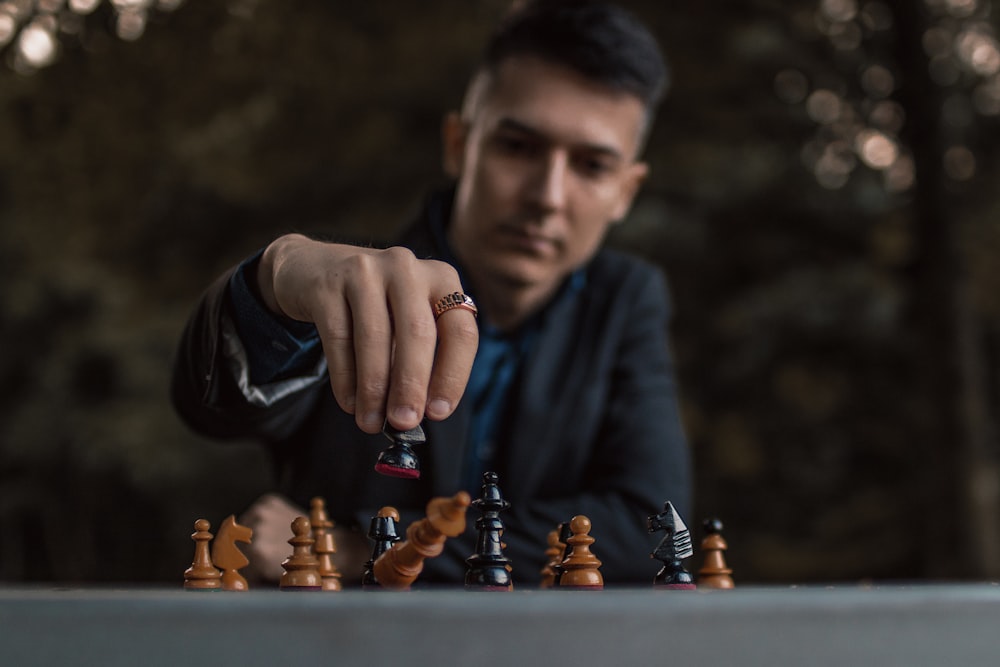 a man playing a game of chess on a table