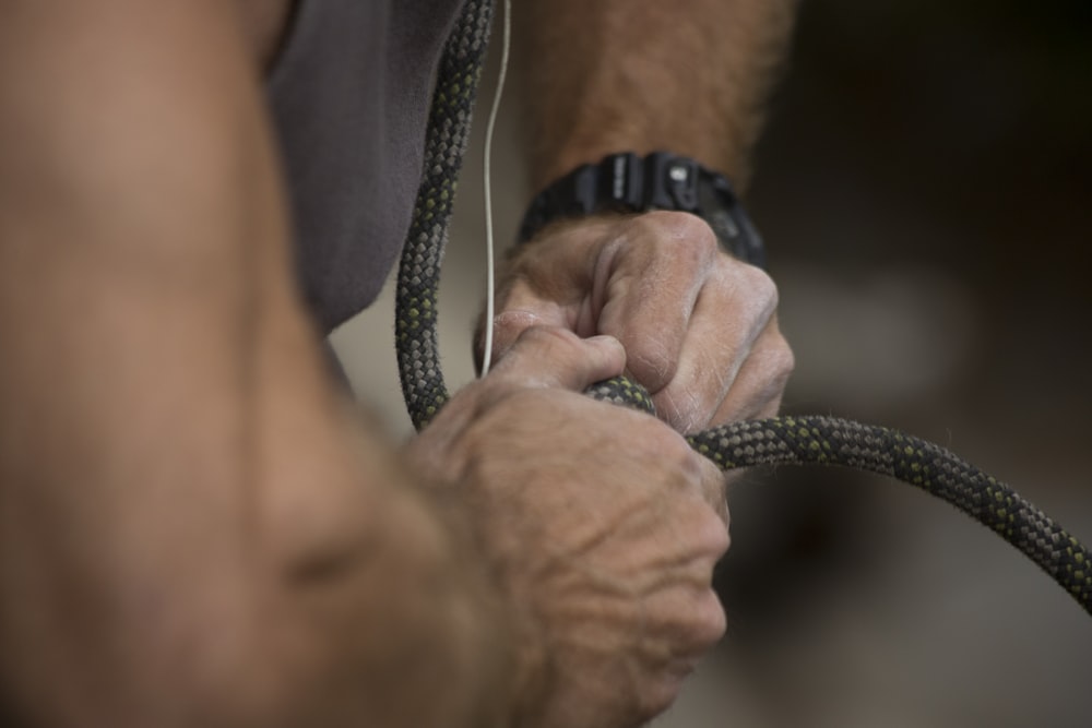 a close up of a person holding a hose