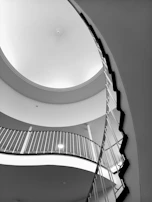 Monochrome image capturing a sleek staircase with contrasting light and dark tones.