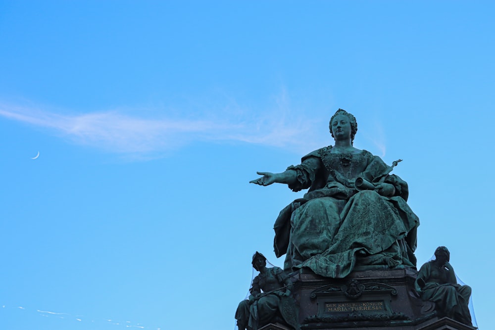 a statue on top of a building with a sky background