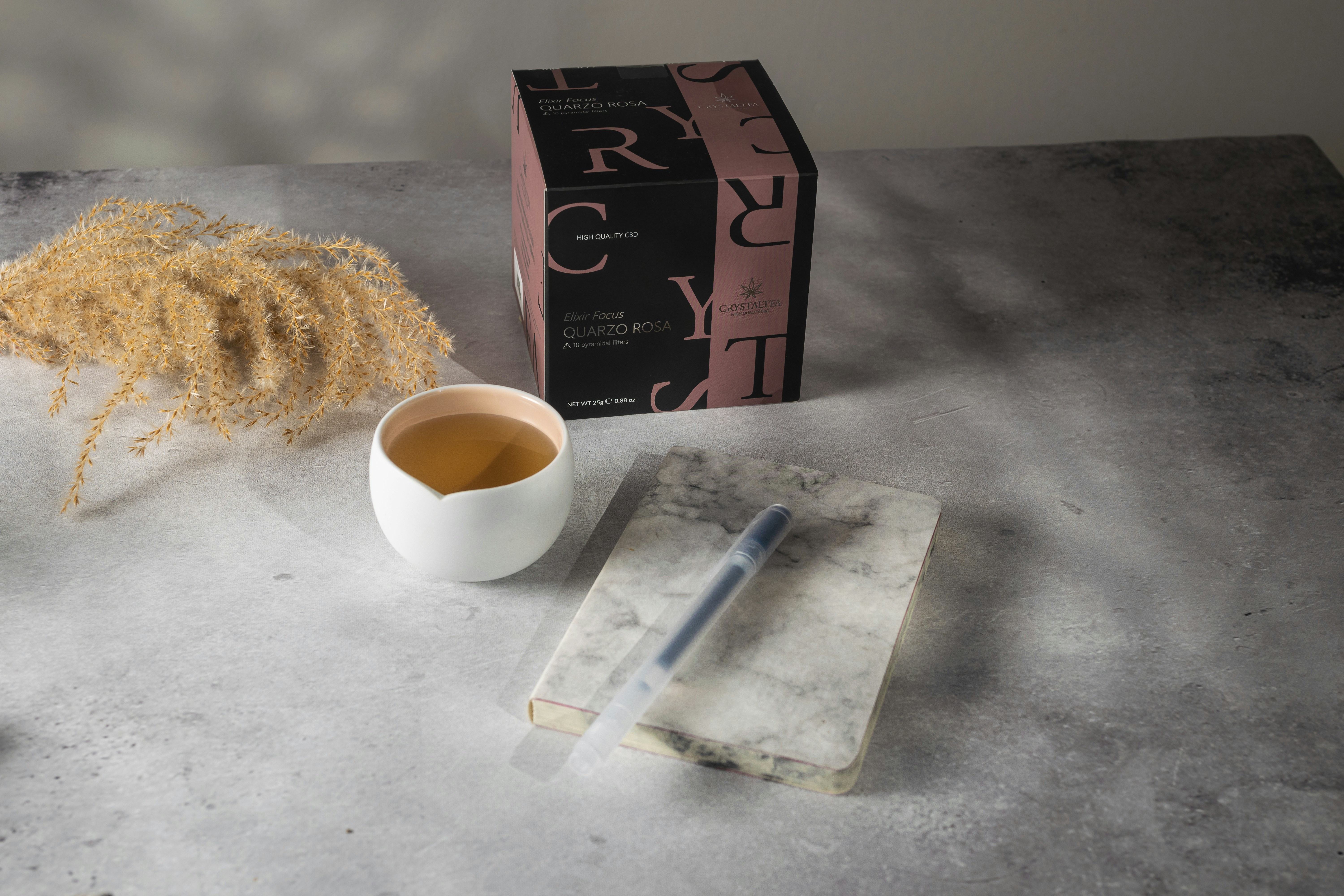 a cup of tea next to a box of cereal