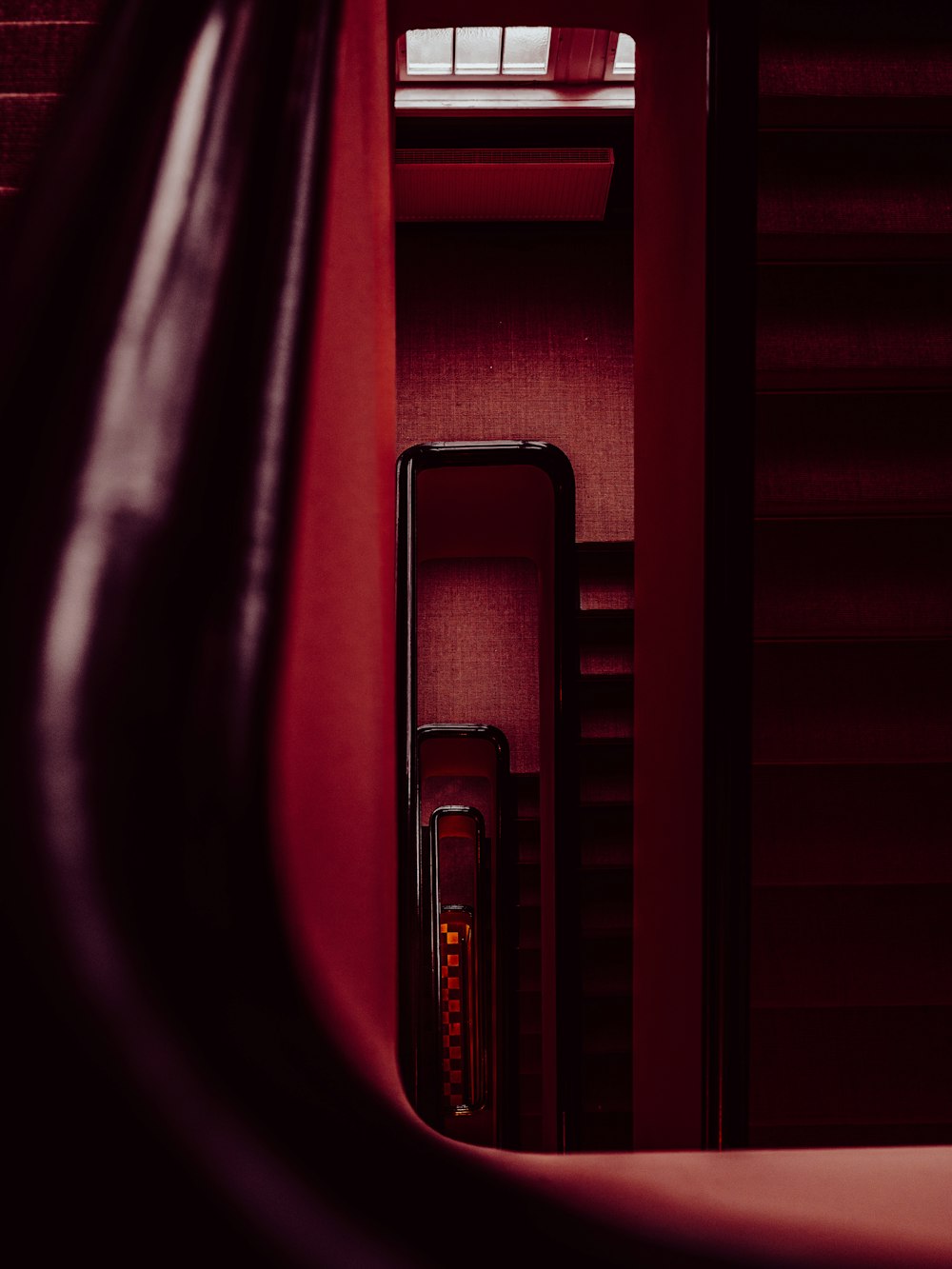 a close up of a red wall with a window