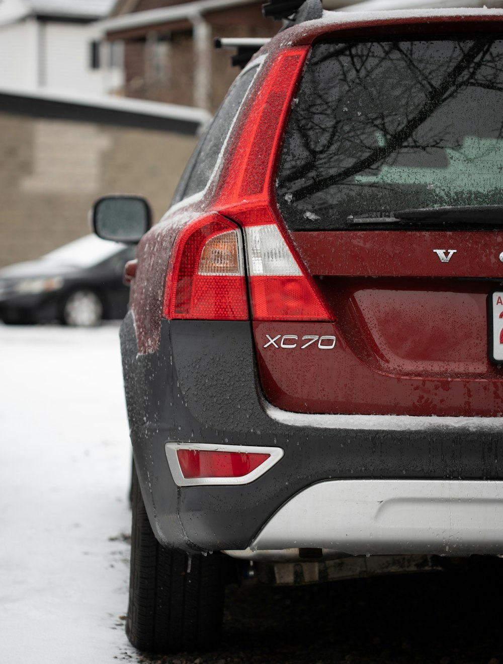 a red car parked on a snowy street