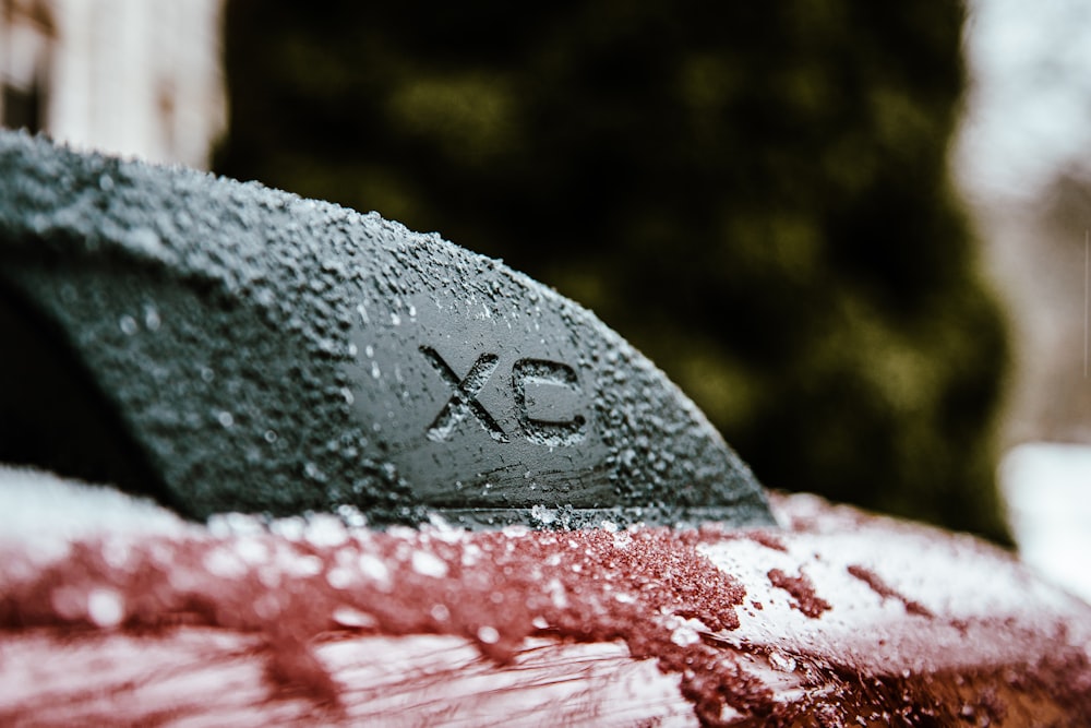 a close up of a car with snow on it