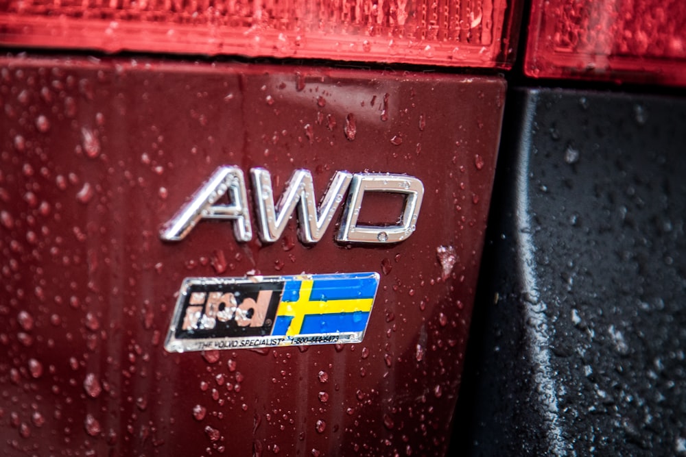 a close up of the emblem on a red car