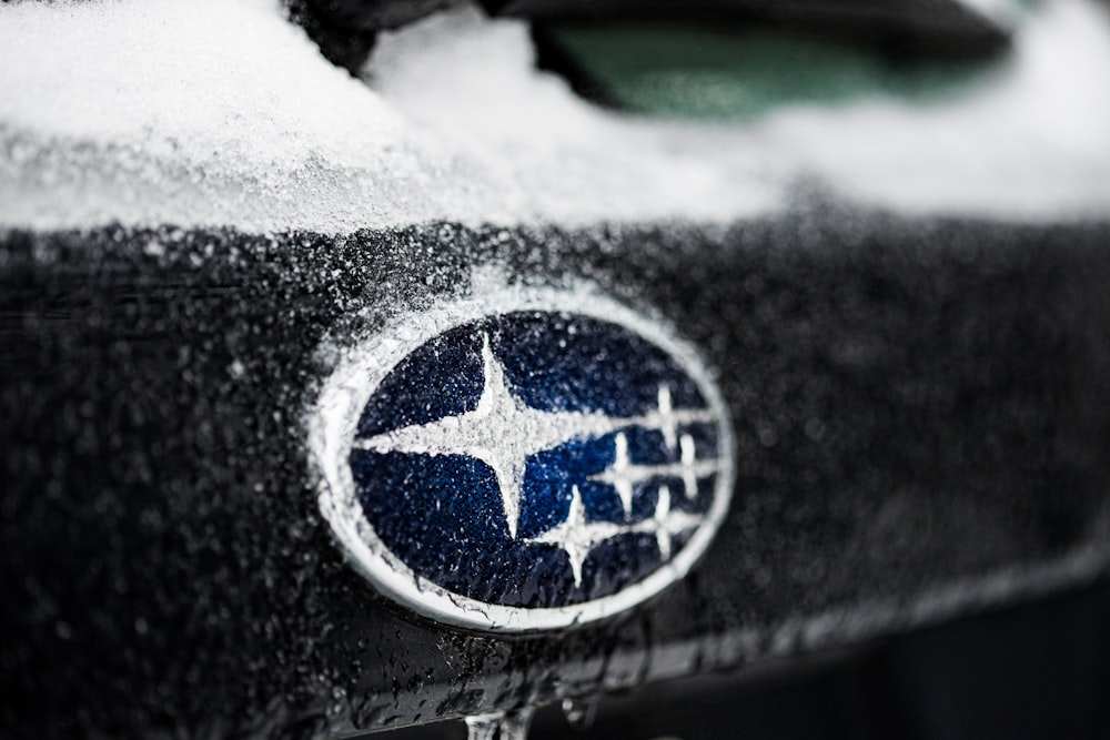 a close up of a car with snow on it