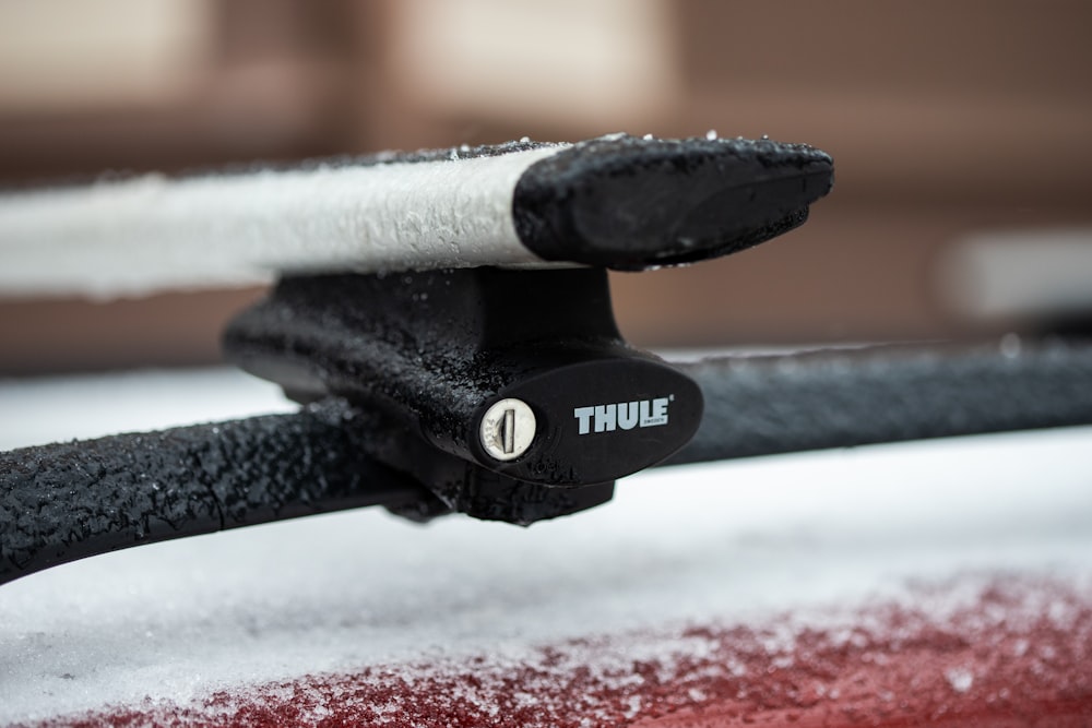 a close up of the handle of a car covered in snow
