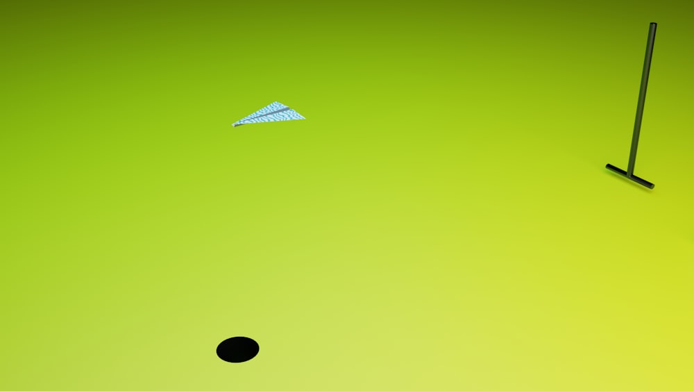 a green background with a black object and a white object
